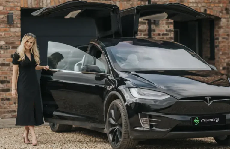 A photo of Jordan Brompton with a Tesla