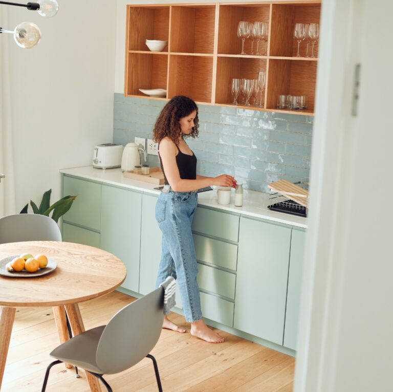 woman in the kitchen using hot water heated with eddi